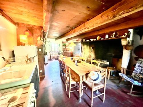 a kitchen with a large wooden table in a room at Le Cheix in Ambert