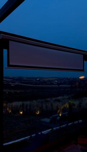 a window view of a city at night at Spemaré Residence Halkidiki in Nea Kalikratia