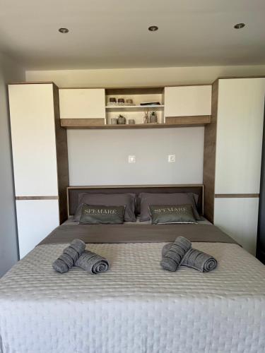 a bed with two pillows on it in a bedroom at Spemaré Residence Halkidiki in Nea Kalikratia