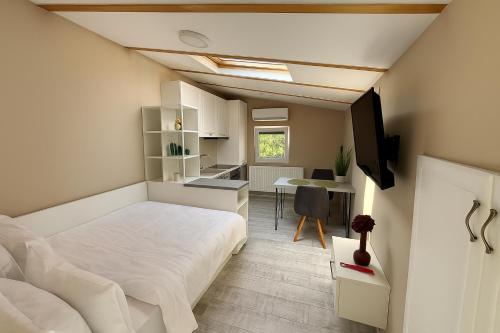 a bedroom with a white bed and a desk at Arena 7-17 Central Suites in Cluj-Napoca