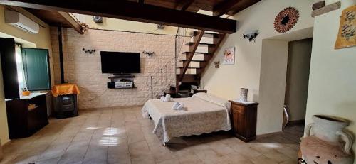 a living room with a table and a tv at La Rondine in Villamassargia
