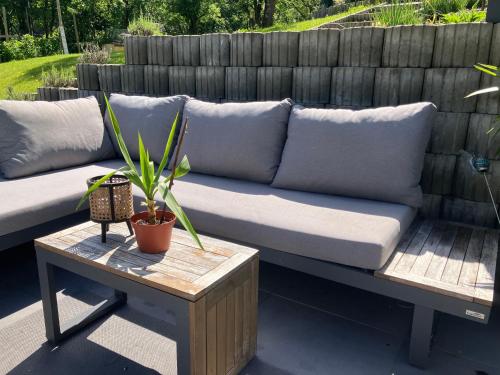 a couch sitting on a patio with a table at Ferienwohnung in Moosburg 