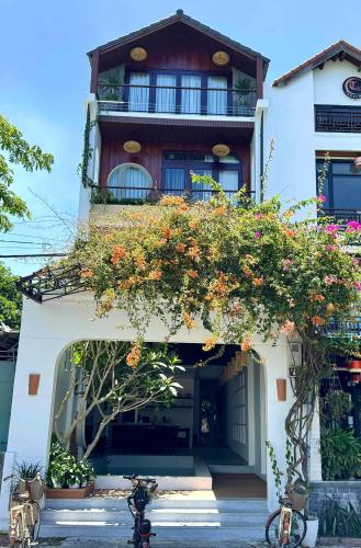 a building with flowers on the front of it at Anriva Hoi An in Hoi An