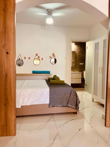 a bedroom with a large bed with lights on it at Seagarden Hideaway - 1bed apt in Paphos