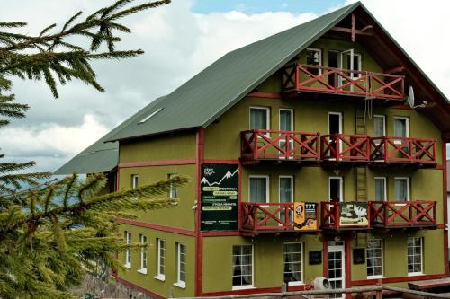 a building with a balcony on the side of it at Robert Hotel in Dragobrat