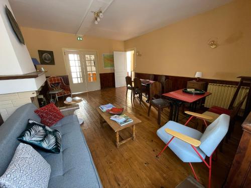 a living room with a blue couch and a table at Le Rocher in Barbazan