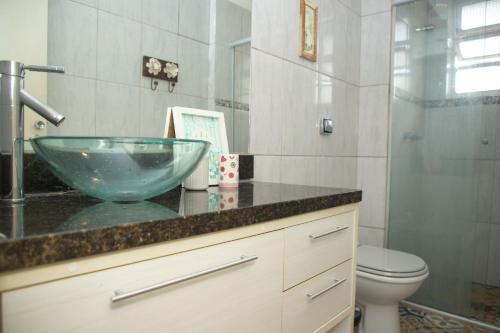 a bathroom with a glass bowl sink on a counter at Entre Parque Moinhos e Country Club POA ZG6320 in Porto Alegre