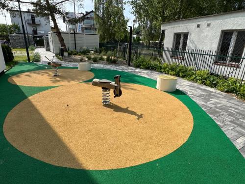 a playground with a toy in the middle of a yard at Klif Apartamenty Posesja Plażowa in Grzybowo