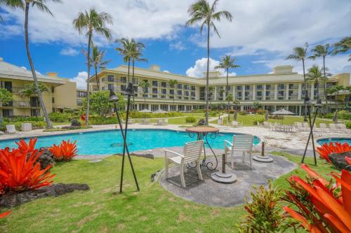 a resort with a pool and a table and chairs at Lagoon View Resort Retreat in Lihue