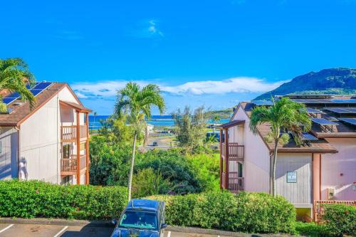 a parking lot with houses and palm trees at Central and Bright 2 BR, 2 BA, Pool and Oceanview in Lihue