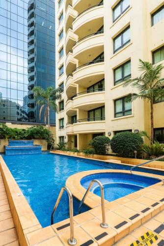 a swimming pool in front of a building at Stylish City Stay in Parramatta Pool , Parking in Sydney