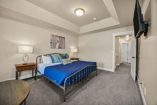 a bedroom with a bed and a tv in it at Bear Lake Escapes Garden City retreat in Garden City