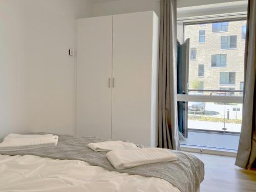 Ένα ή περισσότερα κρεβάτια σε δωμάτιο στο Convenient Apartment for 2
