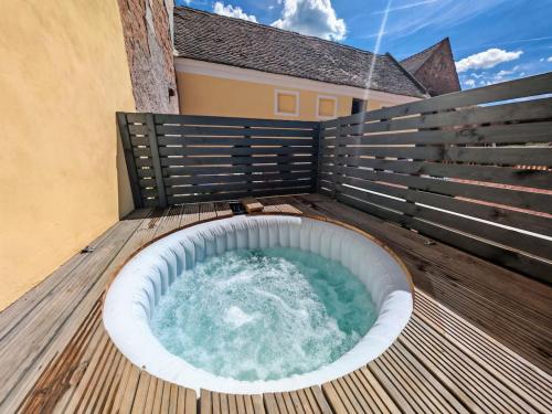 a hot tub on the deck of a house at The Old Bakery at Sobechleby in Blšany