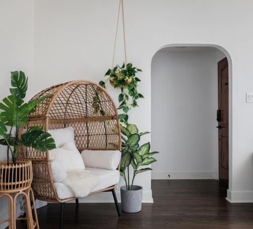 a rattan chair in a room with plants at Iconic LACasita -FoodieBobaliciousCity- Mins2DTLA in Alhambra