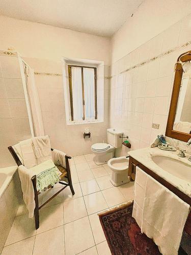 a bathroom with a toilet and a sink and a tub at La Casa della Nonna in stile antico in Castel del Rio