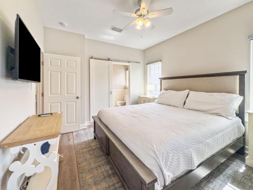 a bedroom with a bed and a flat screen tv at Seagrove, 2 Bd , Sleeps 8, Stillwater 30A, Walk to Beach ,Pool in Santa Rosa Beach