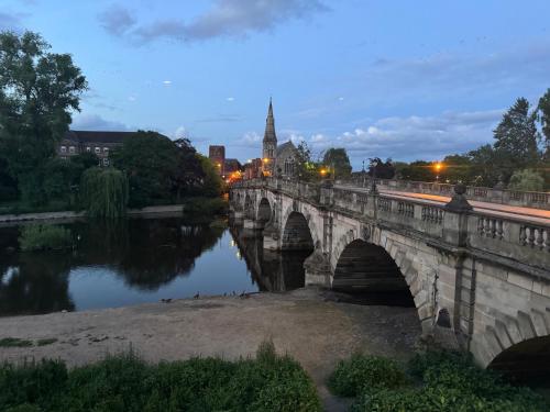 a bridge over a river in a city at night at English Bridge Court in Shrewsbury