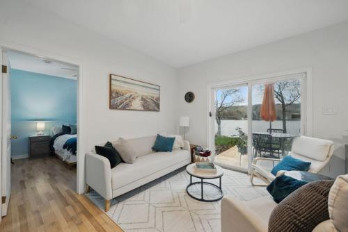 a living room with a couch and a table at The Tranquil lake-house at Fletchers Lake in Fall River