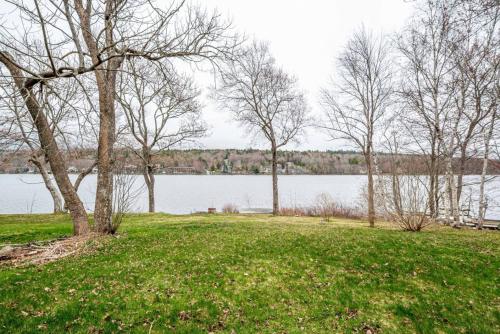 a park with trees and a body of water at The Tranquil lake-house at Fletchers Lake in Fall River