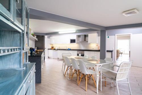 a kitchen and dining room with a table and chairs at Vila da Falésia-With Pool and views in Caniço
