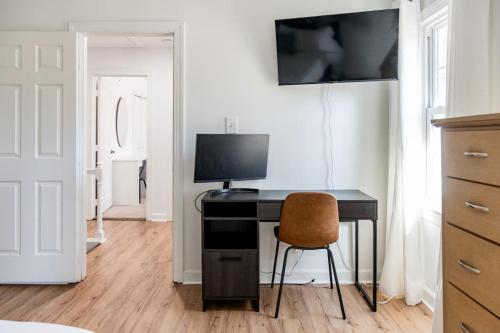 a desk with a computer and a chair in a room at Arcade Private Sauna Large Yard in Apex
