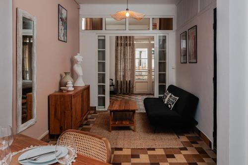a living room with a black couch and a table at Habitation PLUM in Pointe-à-Pitre