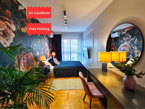 a bedroom with a bed and a desk in a room at Bronowicka Comfort Apartment in Kraków