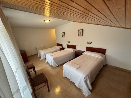 a room with three beds in a room at Hotel Luso Leixoes- in Bergondo
