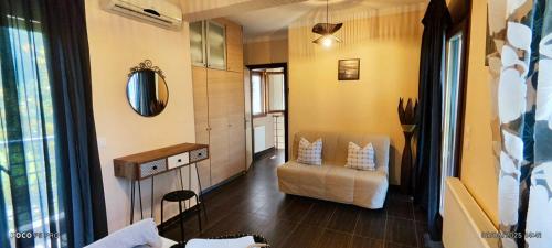 a living room with a couch and a chair at Palmera Pool Villa in Hanioti