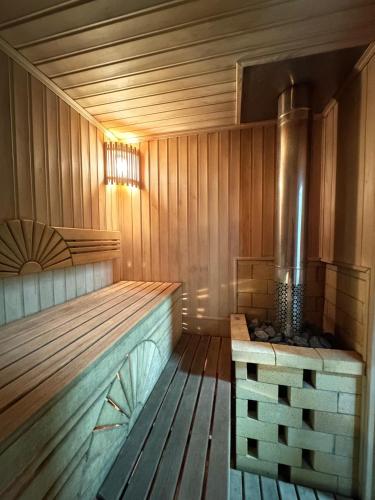 an empty wooden sauna with a wood floor at Altygat Lodge Barskoon in Barskoon