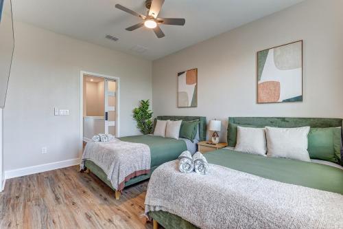 a bedroom with two beds and a ceiling fan at 3 Bedroom 4 Bathroom House Tampa Sleeps 10 Private Garage Near Stadium in Tampa