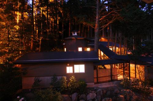 a small house with a slide on the roof at night at かっぱの宿旅館三治郎 in Zao