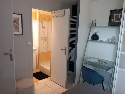La salle de bains est pourvue d'un bureau et d'une douche. dans l'établissement TRES BEL APPARTEMENT Ploumanac'h Centre, à Perros-Guirec