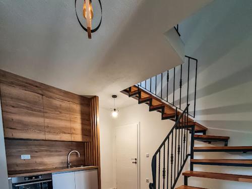 a kitchen with a spiral staircase in a house at Vuletić in Neum