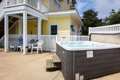 a hot tub in the backyard of a house at Golf Cart Friendly Pool Game Room & Resort Perks in Corolla