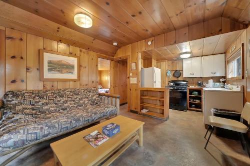 a living room with a bed and a kitchen at Kit Carson Lodge in Kit Carson