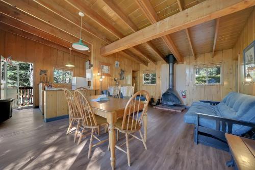a living room with a table and chairs and a couch at Kit Carson Lodge in Kit Carson