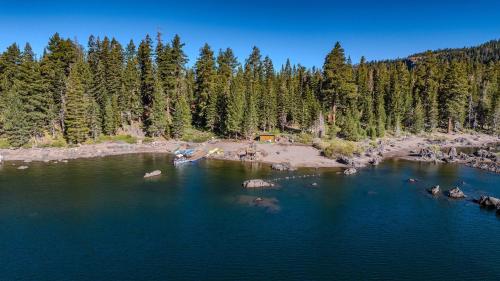 an aerial view of a lake with a beach and trees at Kit Carson Lodge in Kit Carson