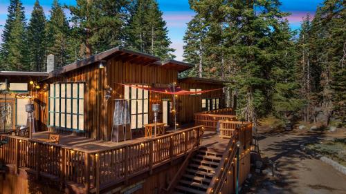a large wooden cabin with benches on a deck at Kit Carson Lodge in Kit Carson