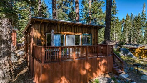 a cabin in the woods with a deck at Kit Carson Lodge in Kit Carson