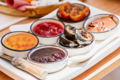 a tray of different types of food on a table at Boii Rest & Breakfast in Siğacık