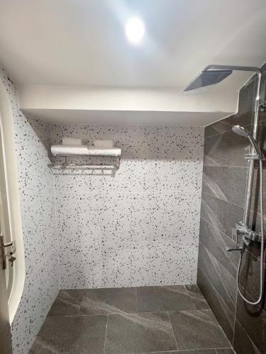 a bathroom with a shower with a toilet and a ceiling at Anriva Hoi An in Hoi An