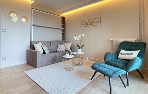 a living room with a couch and a chair at Thelissa Modern Studio - Front Metro station - Free parking in Gentilly