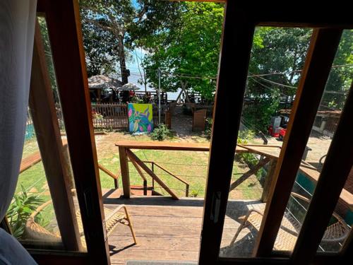 a view of a picnic table from an open door at Pousada AldeiA Cotijuba in Belém