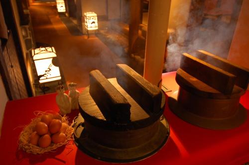 two top hats on a table with a bowl of fruit at かっぱの宿旅館三治郎 in Zao