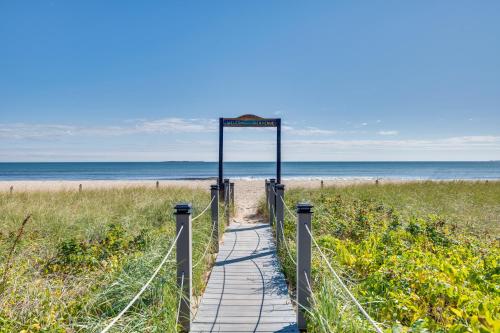 a wooden path to the beach with a sign on it at Walk to Old Orchard Pier Cozy Beachfront Condo! in Old Orchard Beach