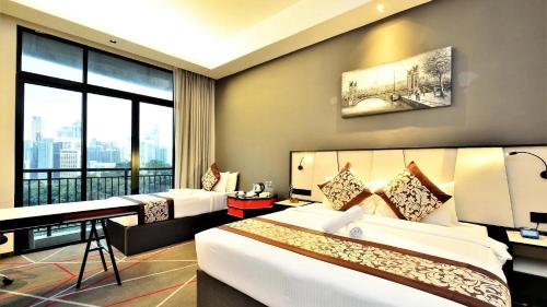 a hotel room with two beds and a large window at Menara M101 Kuala Lumpur By Oak Tree in Kuala Lumpur