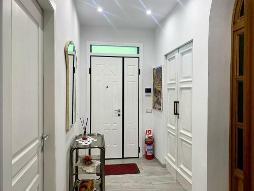 a hallway with a white door and skis on the wall at Chianti 22 in Poggibonsi