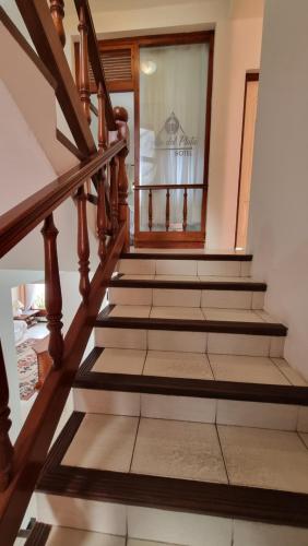 a staircase in a house with wooden railings at Hotel Perla del Plata in Colonia del Sacramento